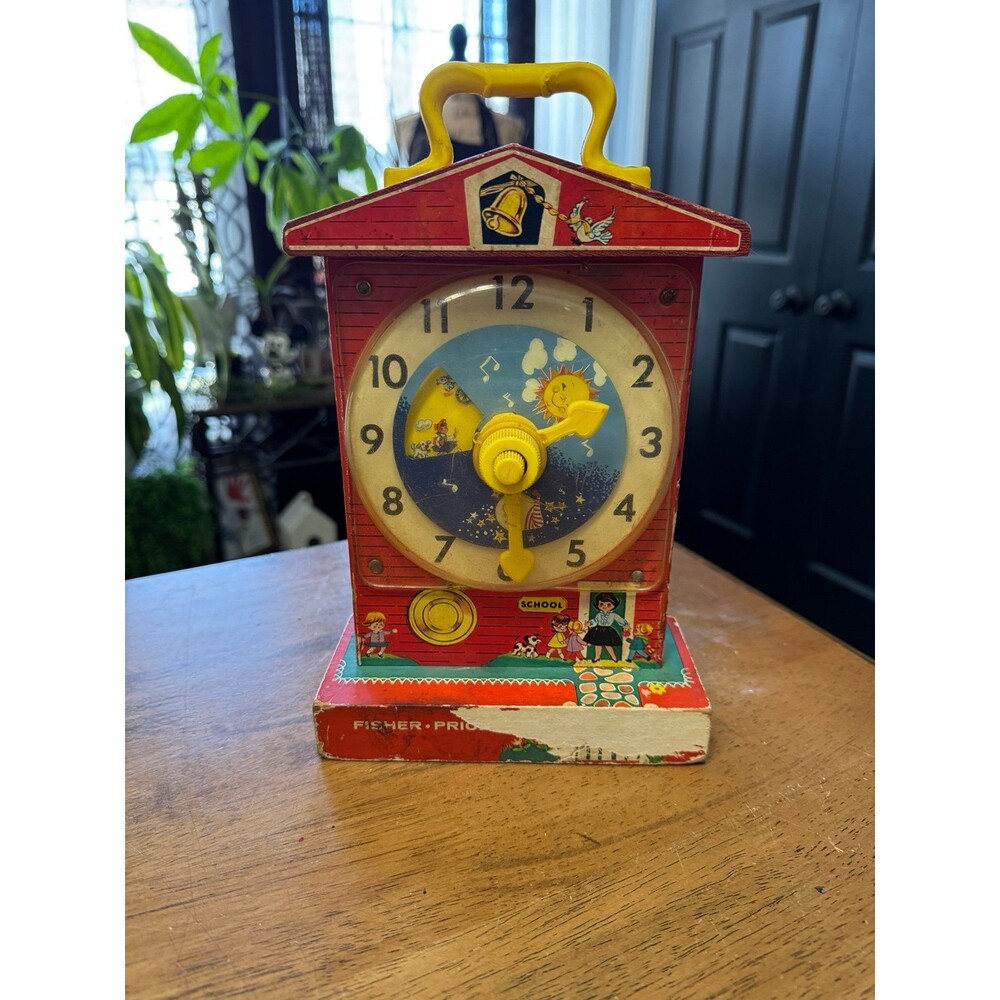 vintage Fisher-Price Music Box Teaching Clock, specifically model #998.